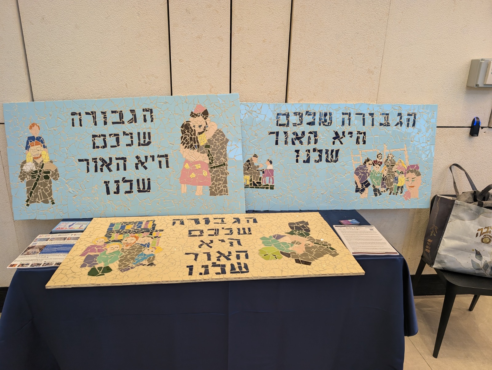 Finished mosaic tribute murals displayed on a table